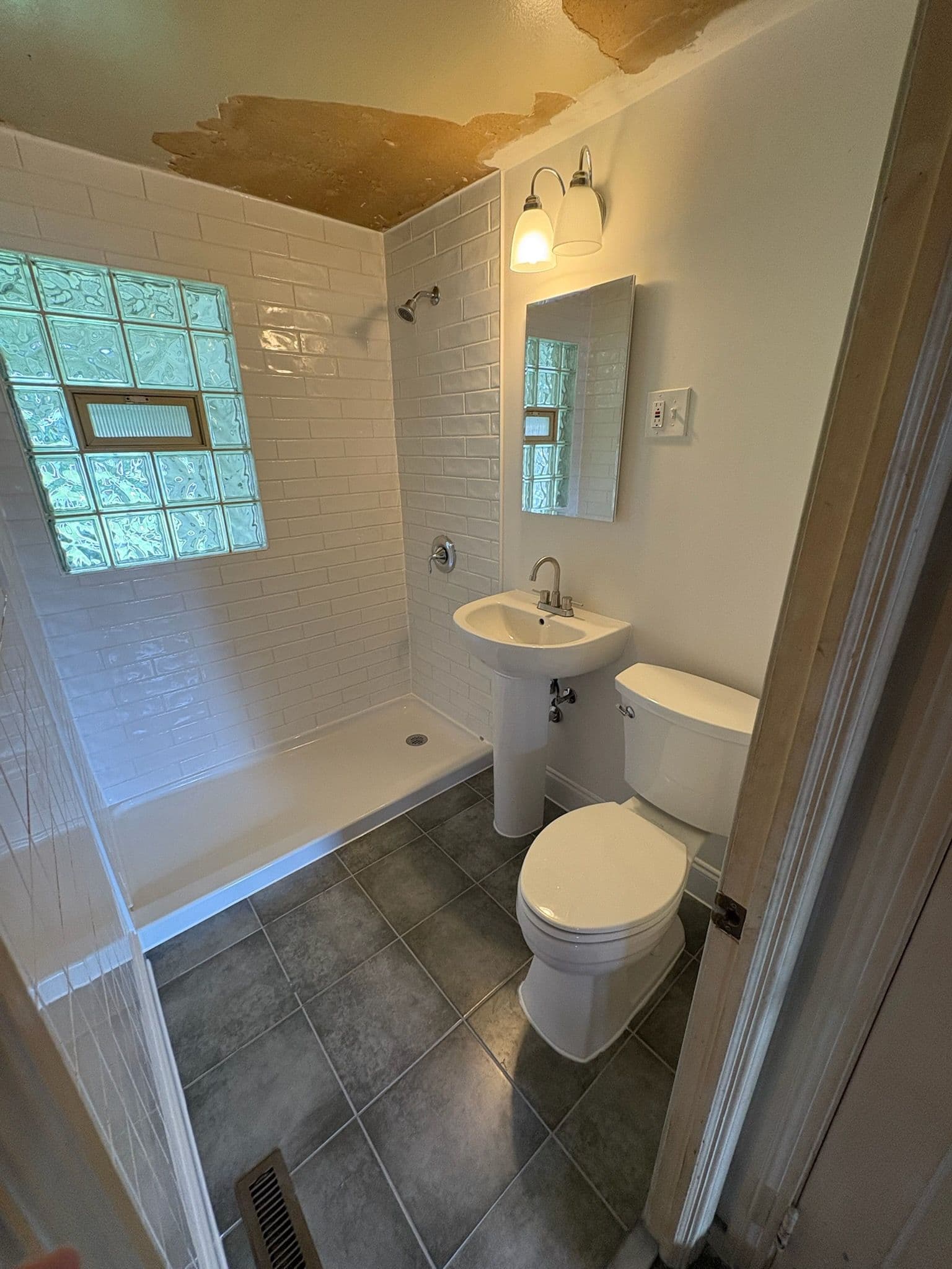 Stylish Small Bathroom Upgraded with Modern White Subway Tiles image